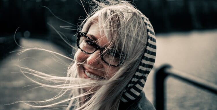 a woman smiling in glasses