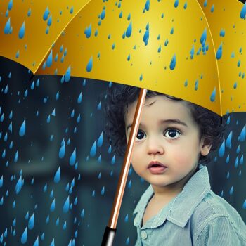 child sad under an umbrella