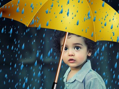 child sad under an umbrella