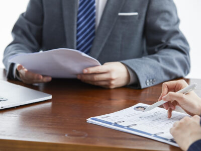 A photo of a lawyer at West Legal in Calgary, Alberta reviewing a severance package for an employee